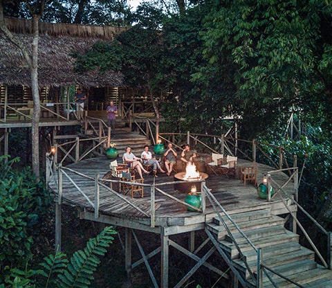 People sitting near the fire at Ngaga Lodge