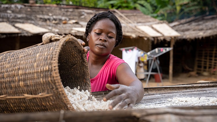 Woman filling a basket in a village in Odzala-Kokoua National Park